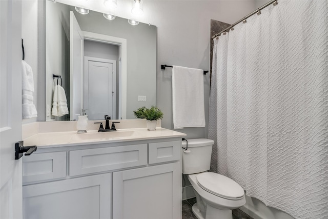 bathroom with a shower with curtain, vanity, toilet, and tile patterned floors