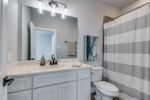 bathroom featuring a shower with curtain, vanity, and toilet