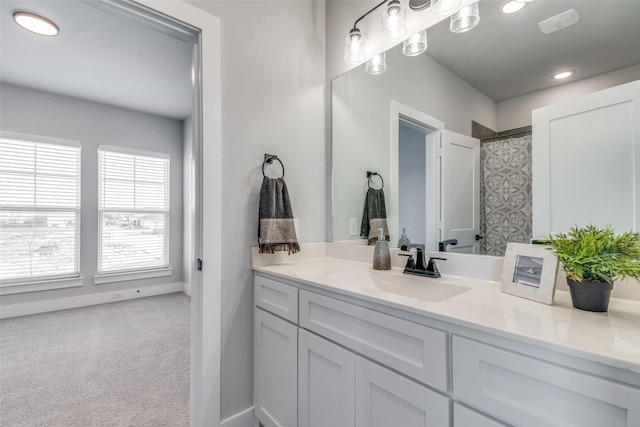 bathroom featuring curtained shower and vanity