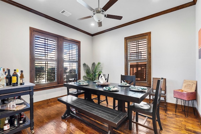 dining area with ceiling fan, crown molding, and dark wood-type flooring