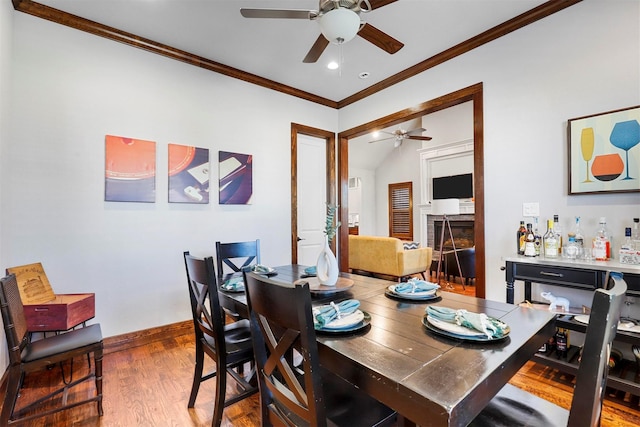 dining space with hardwood / wood-style floors, ceiling fan, and crown molding