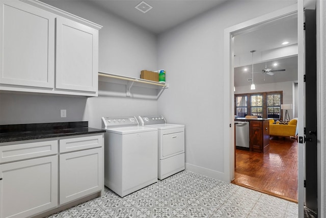 clothes washing area with cabinets, independent washer and dryer, light tile patterned floors, and ceiling fan