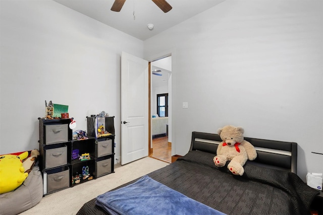 bedroom with ceiling fan and light carpet