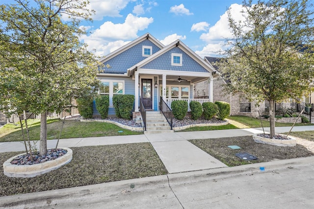 view of front of home featuring a front yard, ceiling fan, and a porch