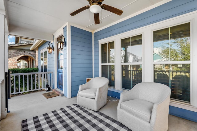 view of patio with ceiling fan and a porch