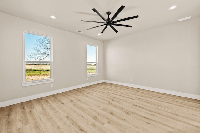 spare room with ceiling fan and light hardwood / wood-style flooring