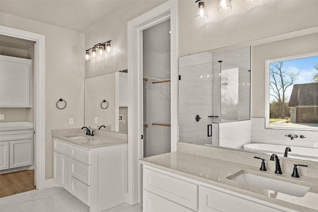 bathroom featuring vanity and an enclosed shower