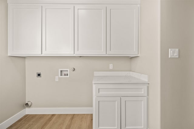 laundry room with cabinets, hookup for a washing machine, light wood-type flooring, electric dryer hookup, and hookup for a gas dryer