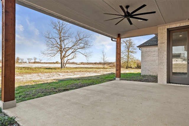 view of patio / terrace featuring ceiling fan and a rural view