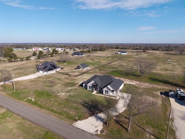 birds eye view of property with a rural view