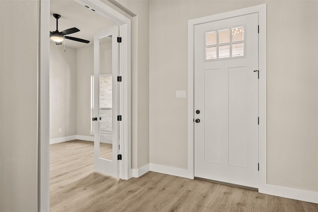 foyer with ceiling fan and light hardwood / wood-style floors