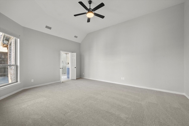 carpeted empty room featuring ceiling fan and lofted ceiling