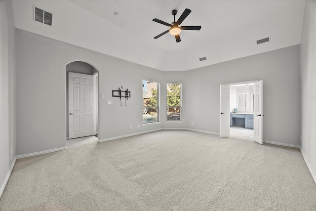 carpeted spare room with ceiling fan