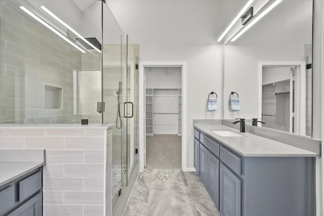 bathroom featuring vanity and an enclosed shower