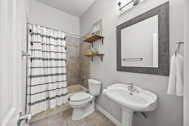 full bathroom with sink, shower / tub combo with curtain, and toilet