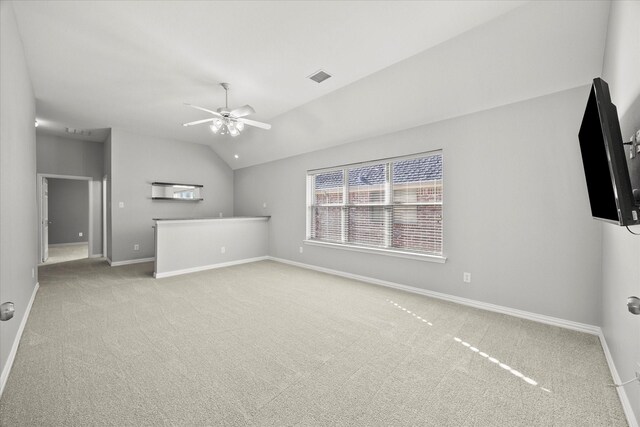 unfurnished living room featuring ceiling fan, light carpet, and lofted ceiling