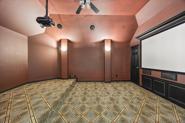 cinema with ceiling fan and lofted ceiling