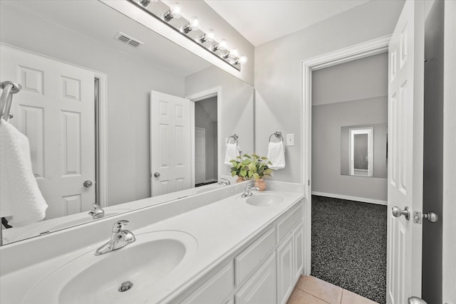 bathroom with tile patterned floors and vanity