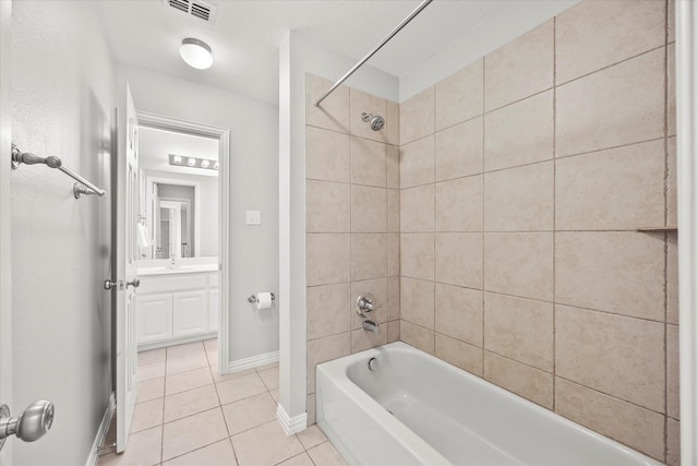 bathroom with vanity, tile patterned floors, and tiled shower / bath