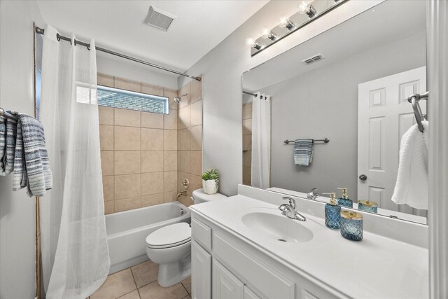 full bathroom with tile patterned flooring, vanity, shower / bath combo, and toilet