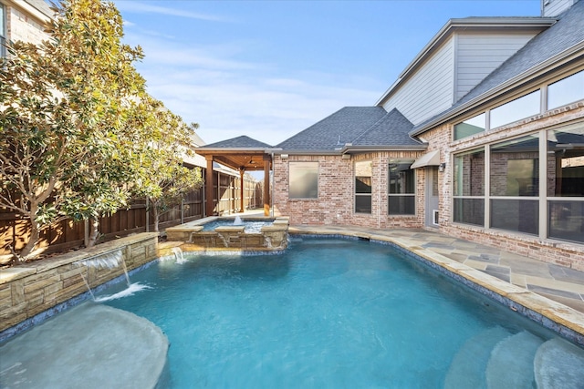 view of pool with pool water feature and an in ground hot tub