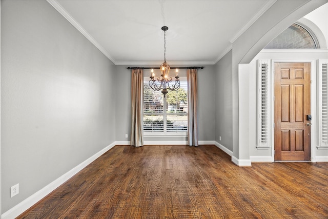 unfurnished dining area featuring dark hardwood / wood-style flooring, an inviting chandelier, and ornamental molding