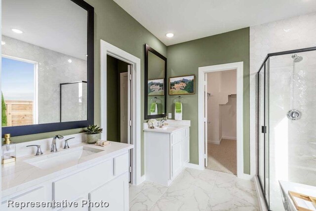 bathroom with walk in shower and vanity