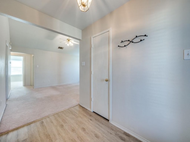 unfurnished room featuring ceiling fan and light carpet