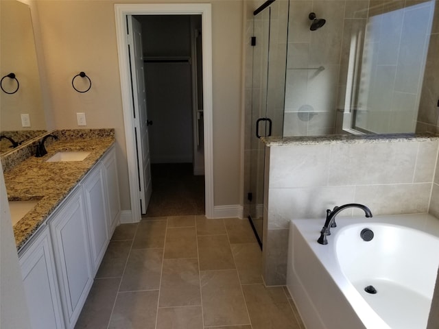 bathroom with tile patterned flooring, vanity, and separate shower and tub