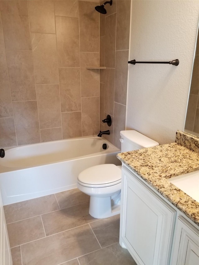 full bathroom with tile patterned flooring, vanity, toilet, and tiled shower / bath