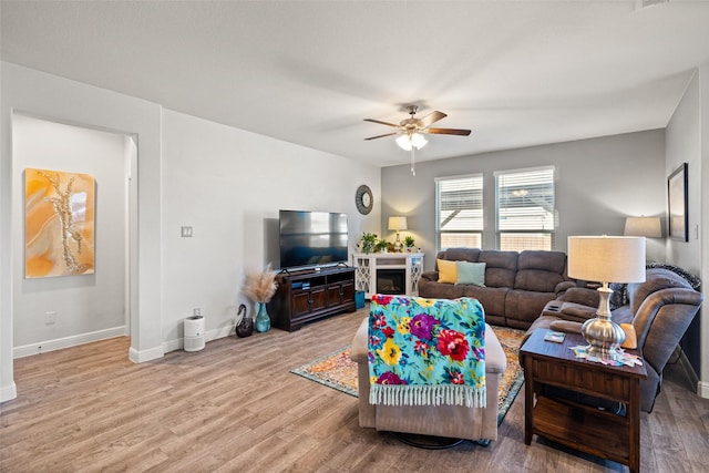 living room with ceiling fan and light hardwood / wood-style floors