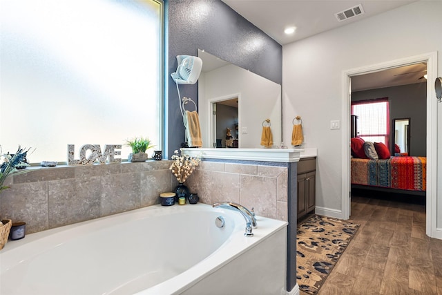 bathroom with a bathing tub and vanity