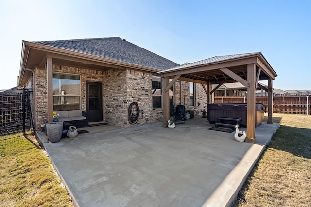 view of patio / terrace featuring a gazebo and a hot tub