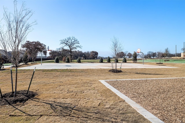 view of yard with basketball hoop