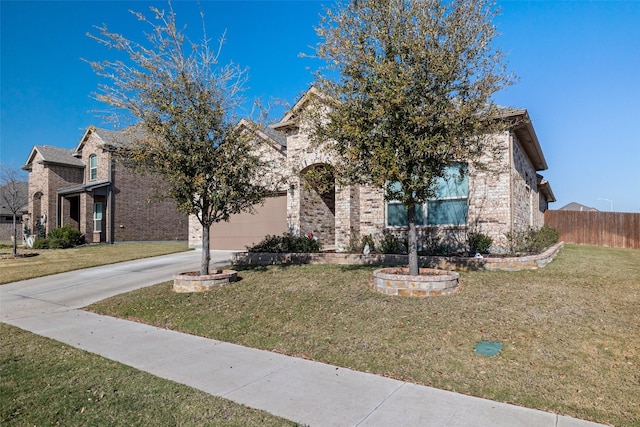 view of property hidden behind natural elements with a garage and a front yard