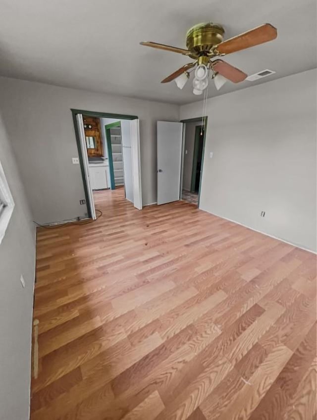 spare room featuring ceiling fan and light hardwood / wood-style flooring