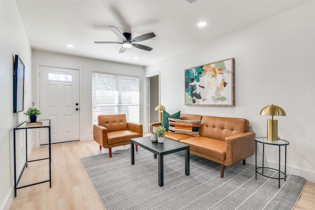 living room featuring ceiling fan and light hardwood / wood-style flooring