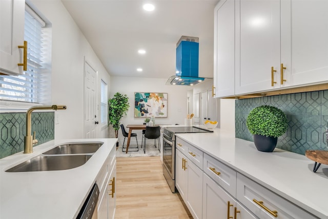 kitchen with ventilation hood, sink, electric range, decorative backsplash, and white cabinetry