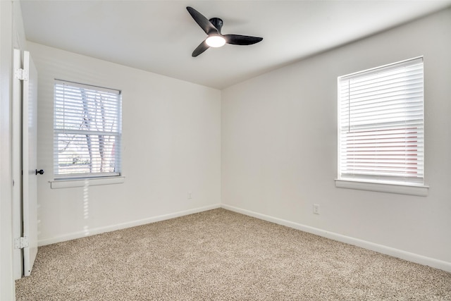 carpeted empty room featuring ceiling fan