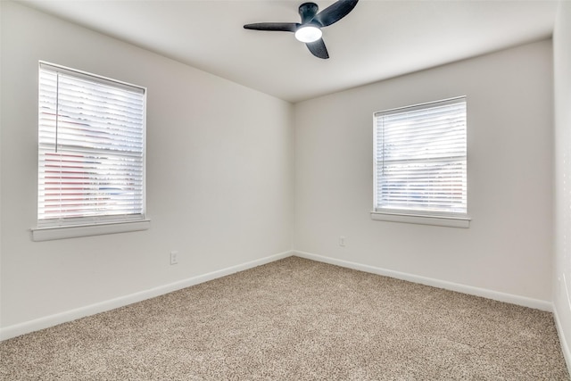 unfurnished room featuring carpet flooring, a wealth of natural light, and ceiling fan