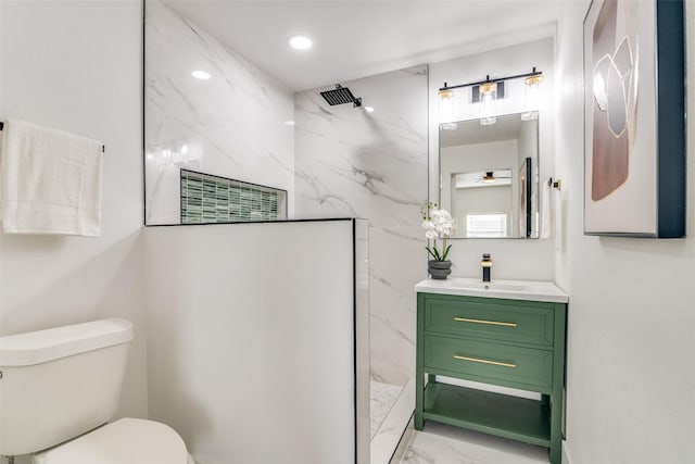 bathroom with a shower, vanity, toilet, and ceiling fan