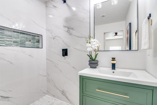 bathroom featuring vanity and tiled shower