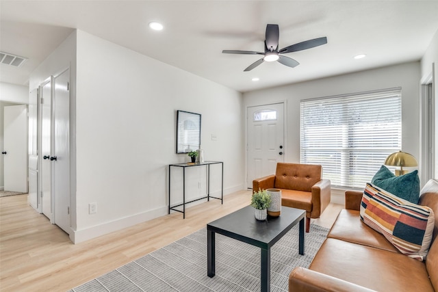 living room with light wood-type flooring and ceiling fan