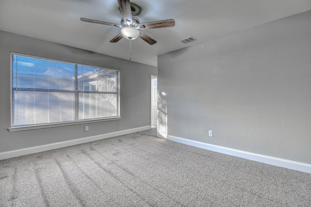 unfurnished room featuring carpet floors and ceiling fan