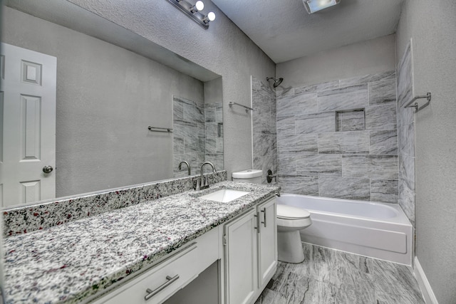 full bathroom featuring vanity, toilet, a textured ceiling, and tiled shower / bath combo