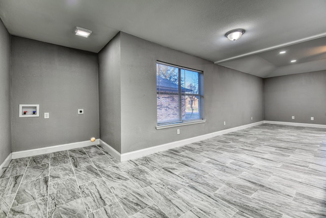 unfurnished room with a textured ceiling