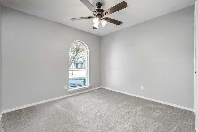 carpeted empty room featuring ceiling fan