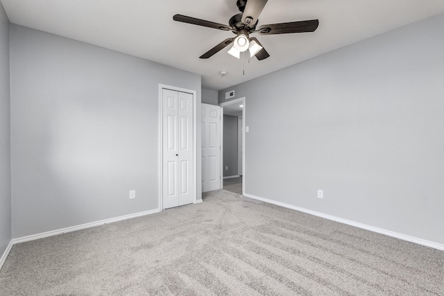 unfurnished bedroom with light carpet, a closet, and ceiling fan