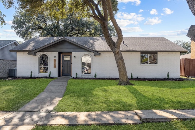 ranch-style house with a front lawn and central air condition unit