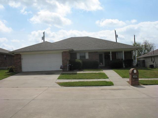 single story home with a front yard and a garage